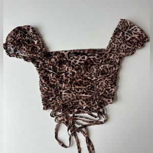 Isabelle's cabinet / salty cheetah print top size small